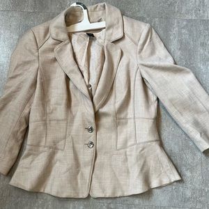 Size 8 light tan blazer with silver buttons in front and in the back sleeves.